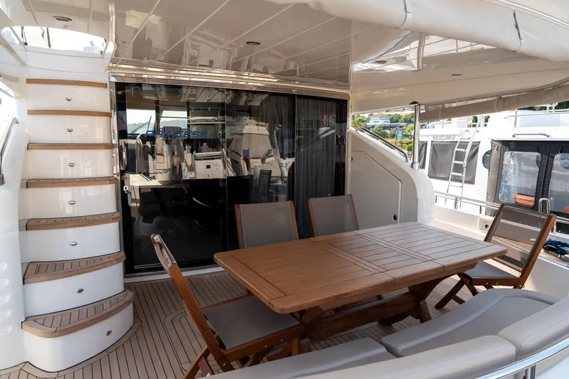  Yacht Photos Pics Luxurious 2008 Princess 67 Flybridge yacht with elegant outdoor dining area and staircase.