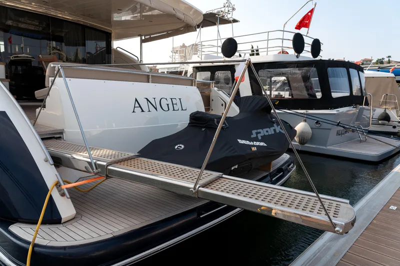  Yacht Photos Pics 2008 Princess 67 Flybridge yacht with jet ski on platform, docked at marina.