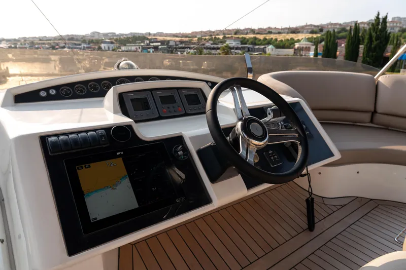  Yacht Photos Pics Helm of 2008 Princess 67 Flybridge yacht with navigation controls and steering wheel.