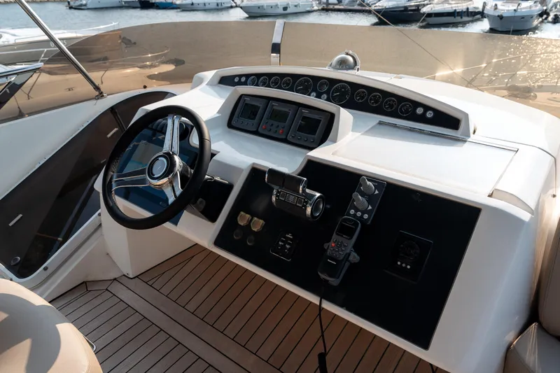  Yacht Photos Pics Helm of 2008 Princess 67 Flybridge yacht with steering wheel and control panel.