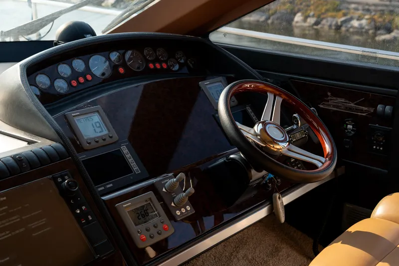  Yacht Photos Pics Helm of 2008 Princess 67 Flybridge yacht with wooden steering wheel and navigation instruments.