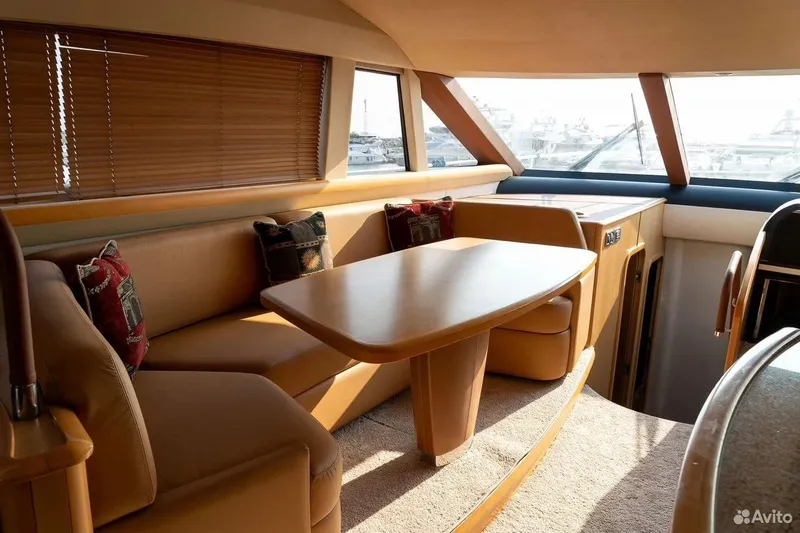  Yacht Photos Pics Luxurious interior of 2008 Princess 67 Flybridge yacht with elegant seating and table.