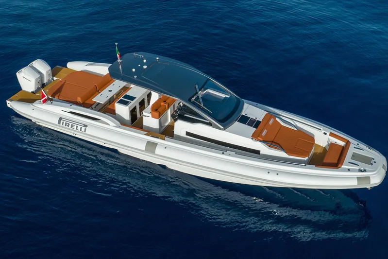  Yacht Photos Pics 2026 Pirelli 50 luxury yacht cruising on clear blue water.