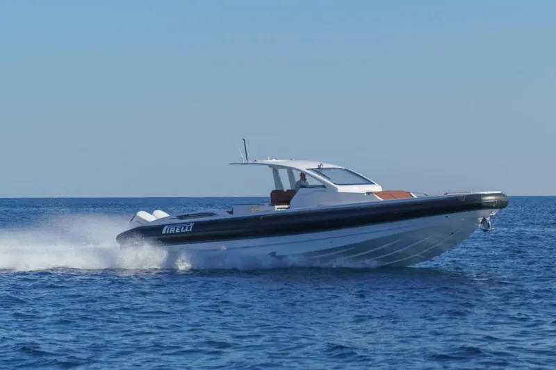  Yacht Photos Pics 2026 Pirelli 50 boat cruising on open water under clear blue sky.