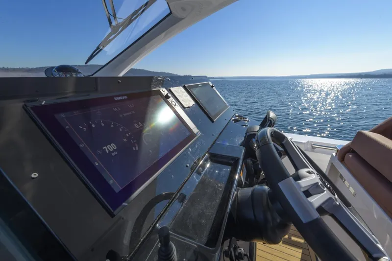  Yacht Photos Pics Helm of 2026 Pirelli 50 boat with digital display, steering wheel, and ocean view.