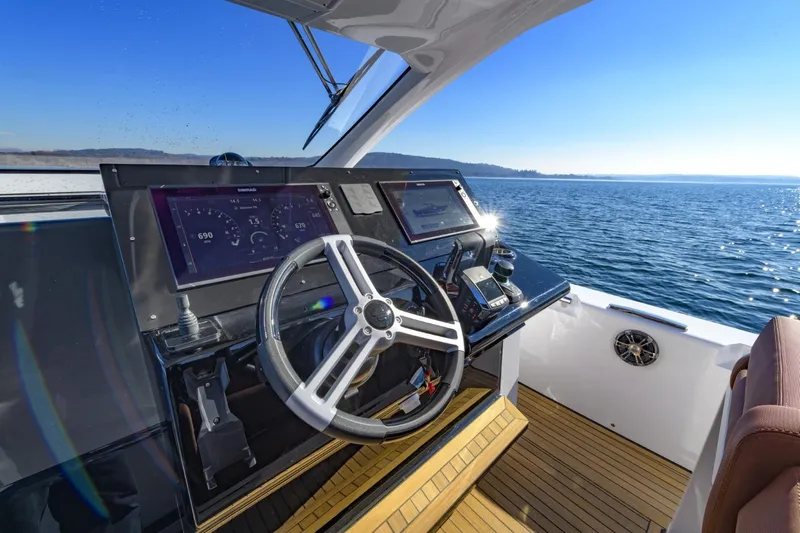  Yacht Photos Pics 2026 Pirelli 50 yacht helm with modern navigation system, steering wheel, and ocean view.