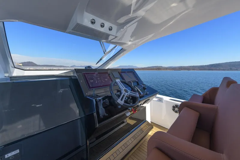  Yacht Photos Pics Helm of 2026 Pirelli 50 yacht with modern controls and scenic water view.