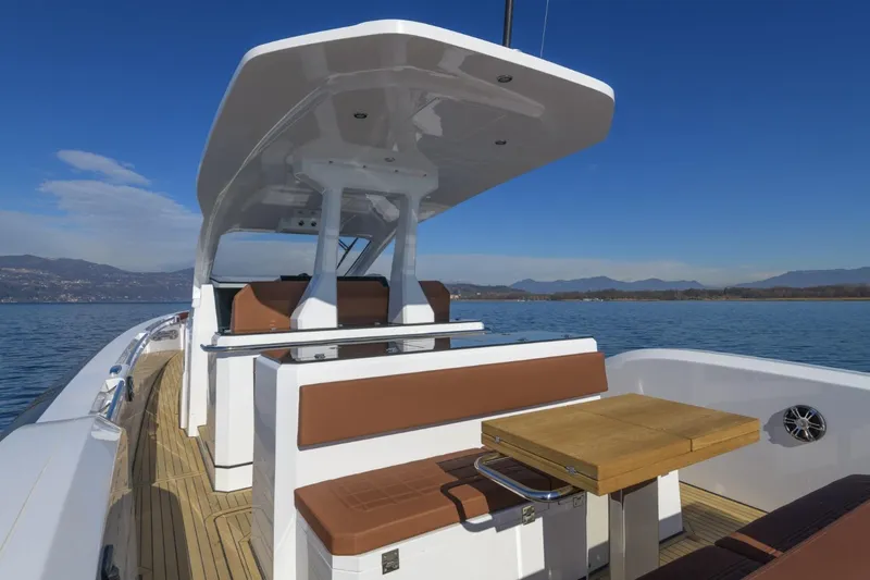  Yacht Photos Pics Modern Pirelli 50 yacht interior with seating and table, 2026 model, on calm water.