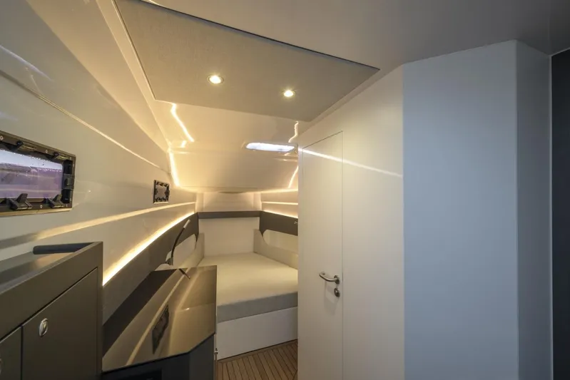  Yacht Photos Pics Modern interior of 2026 Pirelli 50 yacht cabin with sleek design and ambient lighting.
