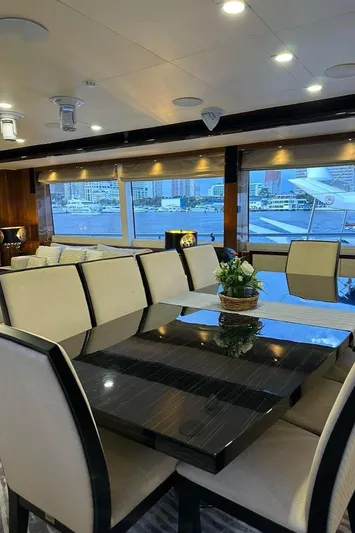 Blue Moon Yacht Photos Pics Luxurious dining area on 2013 Princess M Class 32M yacht with cityscape view.