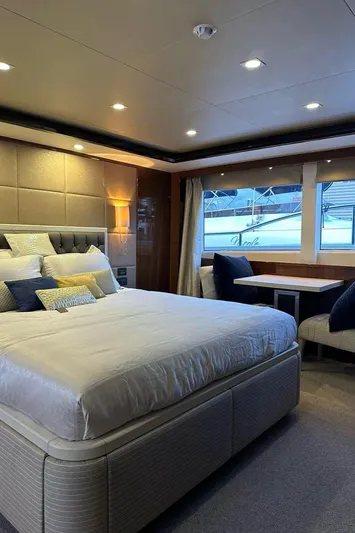 Blue Moon Yacht Photos Pics Luxurious bedroom on 2013 Princess M Class 32M yacht with elegant decor and large windows.