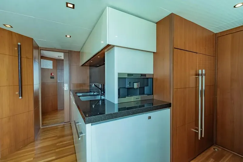 Blue Moon Yacht Photos Pics Luxurious kitchen interior of 2013 Princess M Class 32M yacht with modern wood finishes.