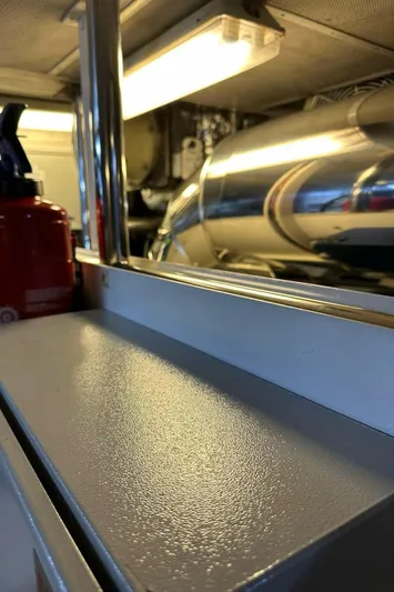 Blue Moon Yacht Photos Pics Engine room of 2013 Princess M Class 32M yacht with metallic surfaces and equipment.