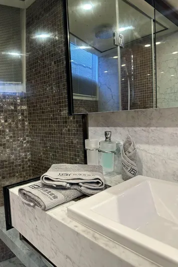 Blue Moon Yacht Photos Pics Luxurious bathroom in 2013 Princess M Class 32M yacht with elegant marble and modern fixtures.