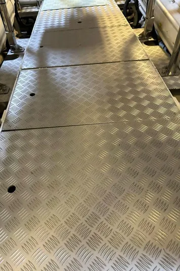 Blue Moon Yacht Photos Pics Engine room walkway of 2013 Princess M Class 32M yacht with metal flooring.