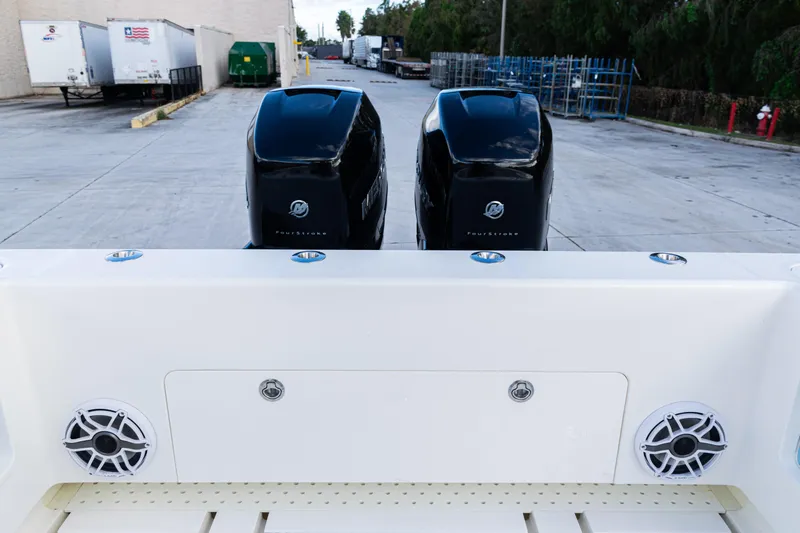  Yacht Photos Pics 2021 SeaVee 322Z boat with dual Mercury FourStroke engines, docked in an industrial area.