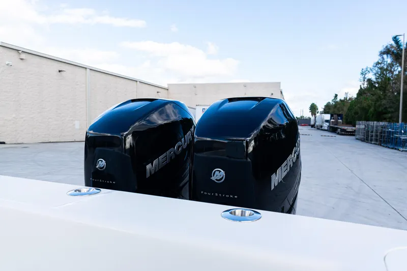  Yacht Photos Pics Twin Mercury outboard engines on a 2021 SeaVee 322Z boat, parked outdoors.