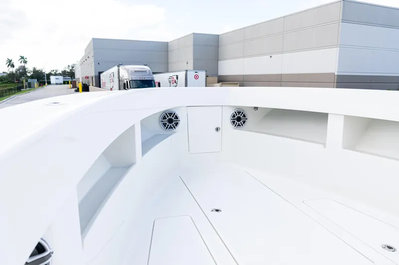  Yacht Photos Pics 2021 SeaVee 322Z boat interior with speakers, docked near industrial buildings.