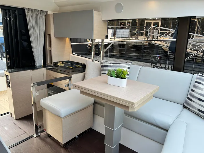  Yacht Photos Pics Modern interior of 2023 Prestige 420S yacht with sleek seating and dining area.