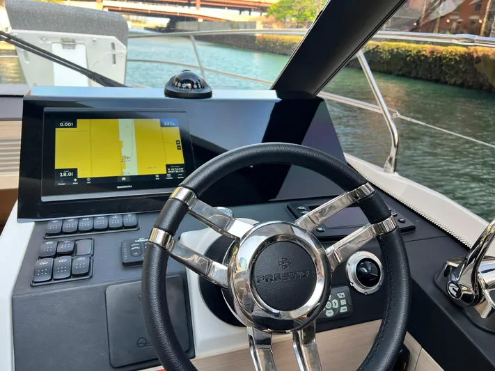  Yacht Photos Pics 2023 Prestige 420S yacht helm with Garmin navigation display and steering wheel.