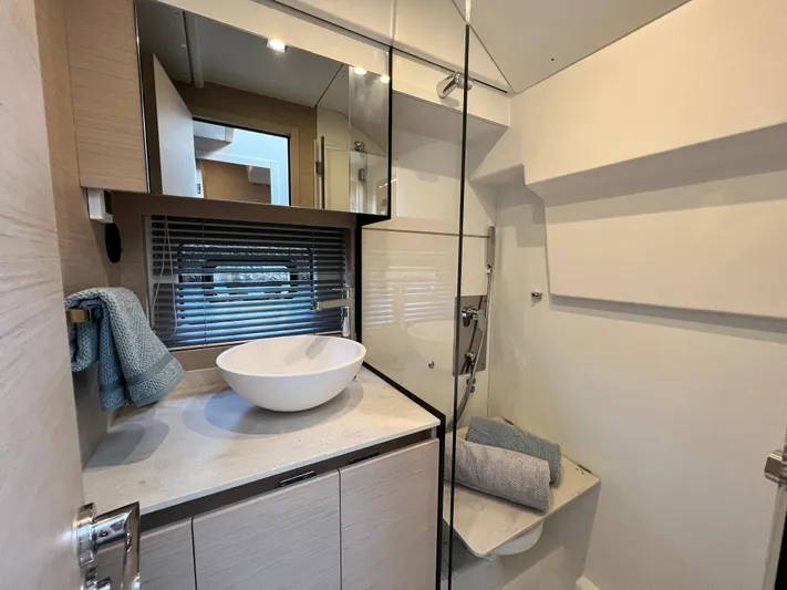  Yacht Photos Pics Modern bathroom in 2023 Prestige 420S yacht with vessel sink and glass shower.