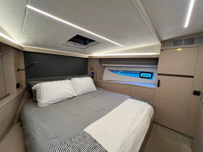  Yacht Photos Pics Luxurious bedroom interior of 2023 Prestige 420S yacht with modern design and ambient lighting.
