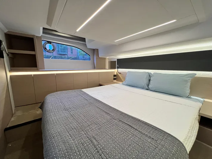  Yacht Photos Pics Luxurious bedroom interior of 2023 Prestige 420S yacht with modern design and ambient lighting.