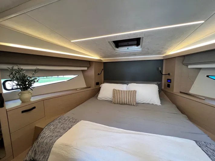  Yacht Photos Pics Luxurious bedroom interior of 2023 Prestige 420S yacht with modern design and cozy bedding.