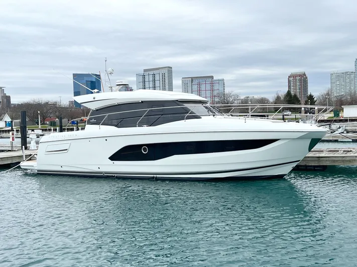  Yacht Photos Pics 2023 Prestige 420S yacht docked in marina, city skyline in background.