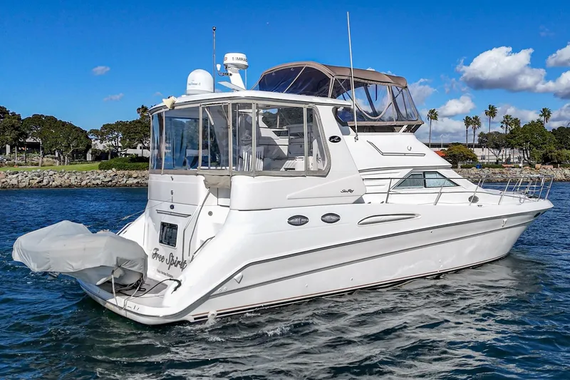 Free Spirit Yacht Photos Pics 1998 Sea Ray 420 Aft Cabin yacht on water, clear sky, coastal background.