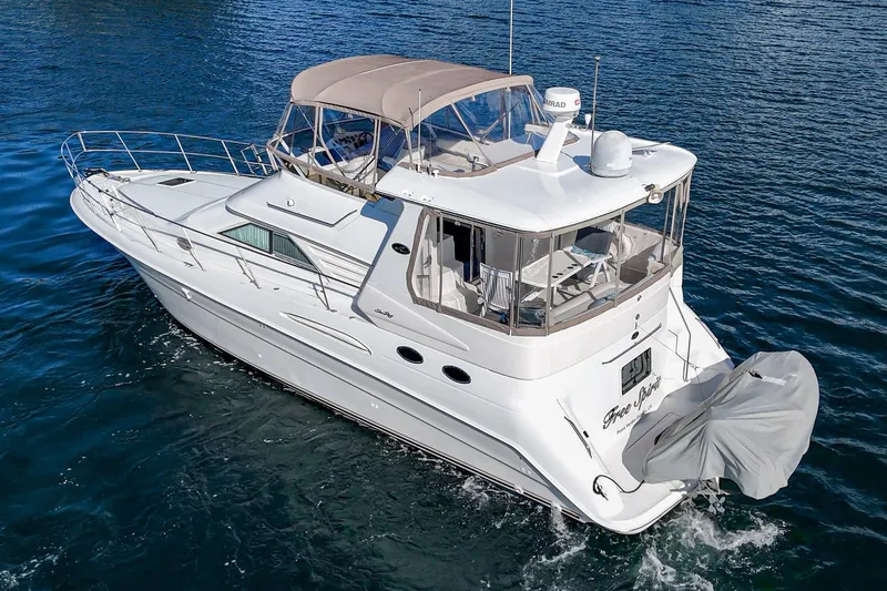 Free Spirit Yacht Photos Pics 1998 Sea Ray 420 Aft Cabin yacht cruising on blue water.