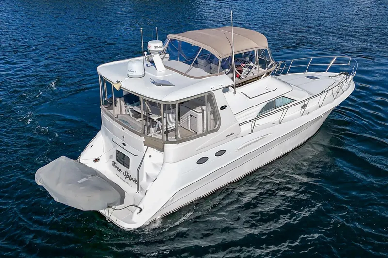 Free Spirit Yacht Photos Pics 1998 Sea Ray 420 Aft Cabin yacht cruising on blue water.