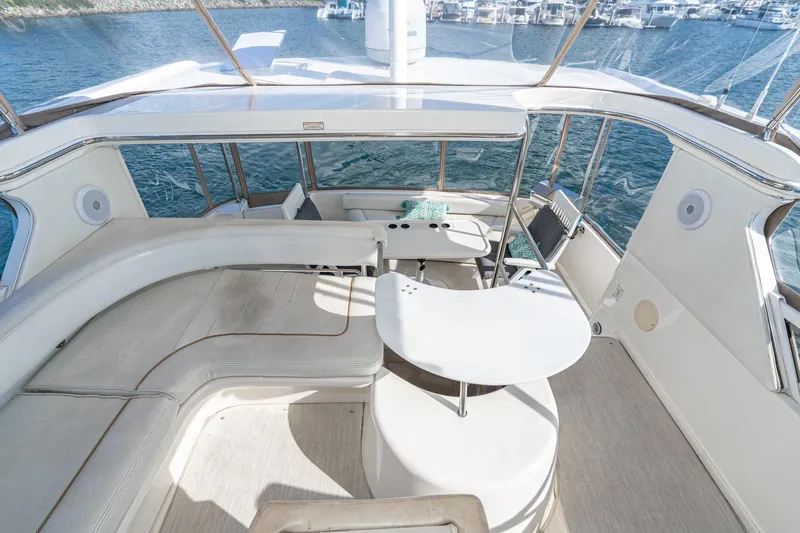 Free Spirit Yacht Photos Pics 1998 Sea Ray 420 Aft Cabin yacht interior with spacious seating and table, overlooking marina.