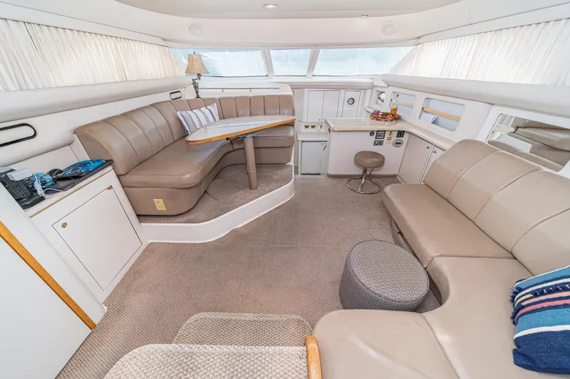 Free Spirit Yacht Photos Pics Luxurious interior of 1998 Sea Ray 420 Aft Cabin yacht with plush seating and elegant decor.