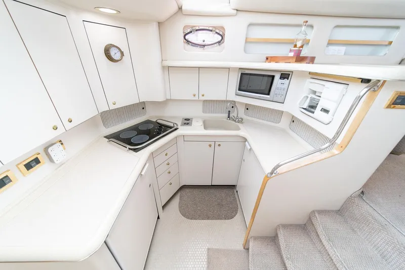 Free Spirit Yacht Photos Pics 1998 Sea Ray 420 Aft Cabin yacht kitchen with modern appliances and white cabinetry.