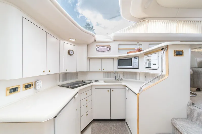 Free Spirit Yacht Photos Pics Luxurious 1998 Sea Ray 420 Aft Cabin yacht kitchen with modern appliances and sleek design.
