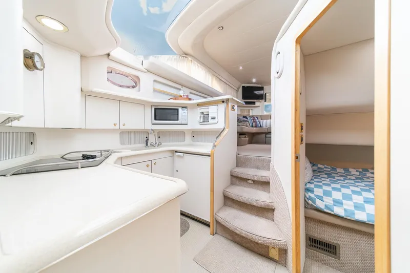 Free Spirit Yacht Photos Pics 1998 Sea Ray 420 Aft Cabin interior with kitchen, stairs, and cozy sleeping area.