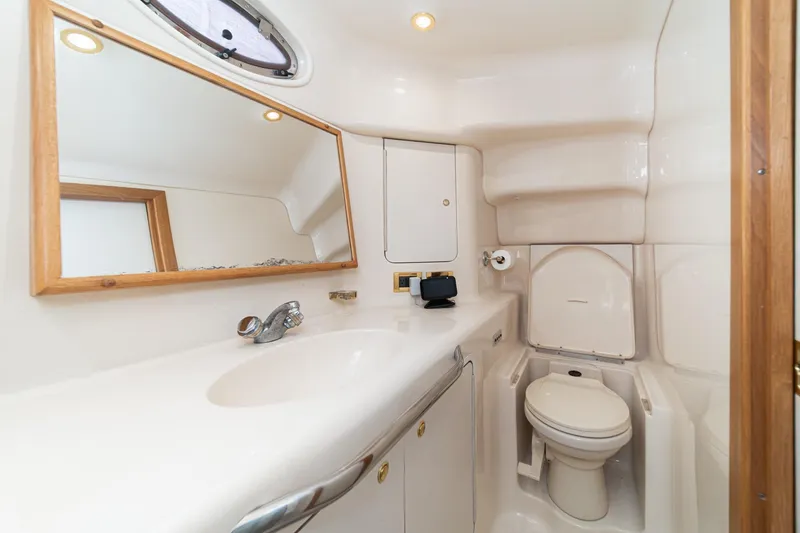 Free Spirit Yacht Photos Pics 1998 Sea Ray 420 Aft Cabin bathroom with sink, mirror, and toilet.