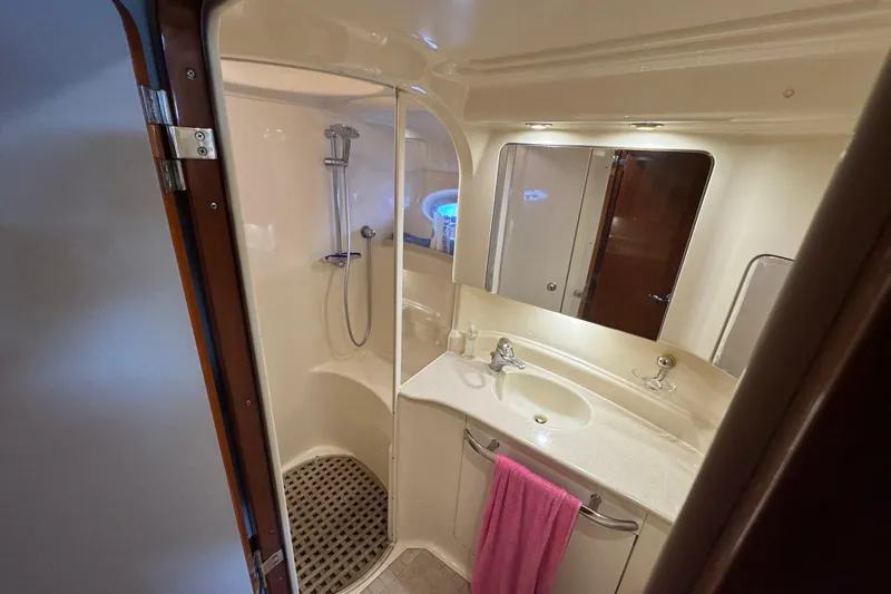 Go Girl Yacht Photos Pics Bathroom interior of 2001 Sea Ray 510 Sundancer yacht, featuring shower and sink.