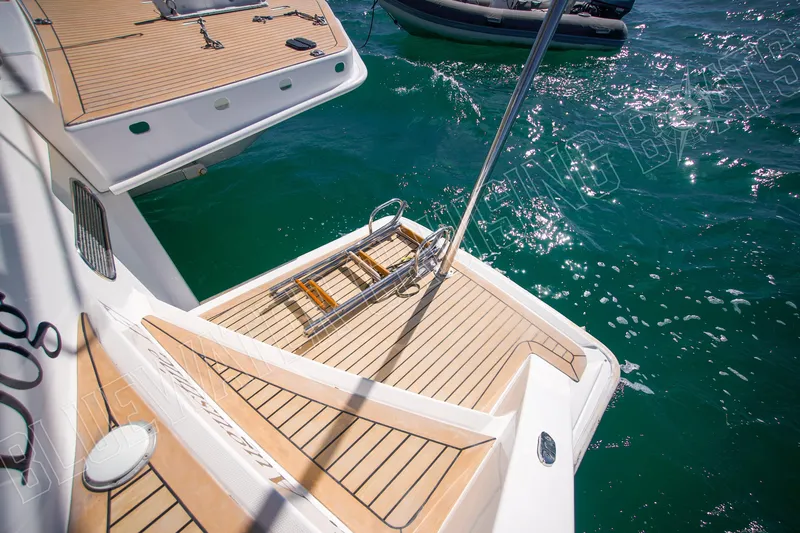 Sea Dog Yacht Photos Pics Luxury Leopard 58 yacht deck, 2020 model, with swim platform and ladder on turquoise water.