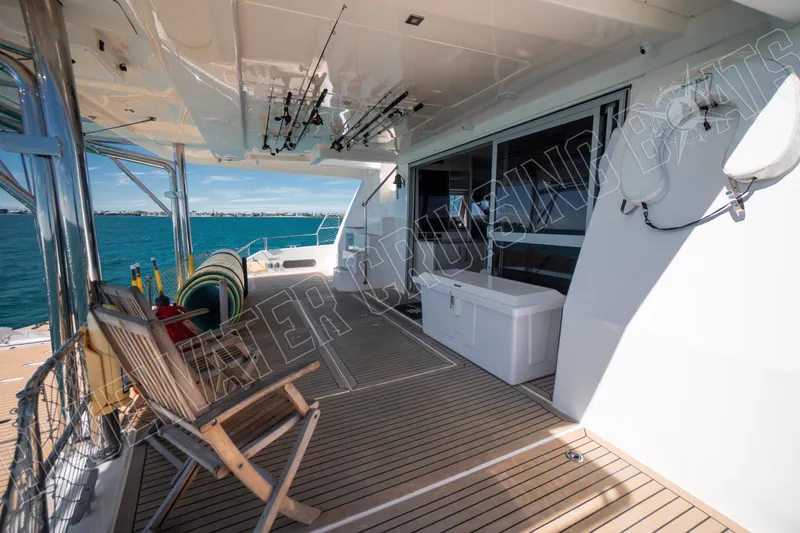 Sea Dog Yacht Photos Pics Spacious deck of 2020 Leopard 58 yacht with fishing rods and ocean view.