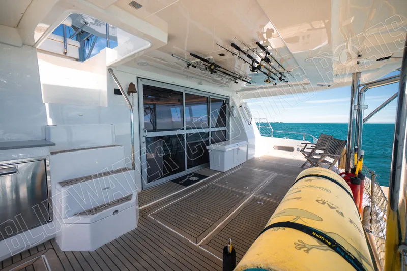 Sea Dog Yacht Photos Pics Luxurious 2020 Leopard 58 yacht deck with fishing rods and ocean view.