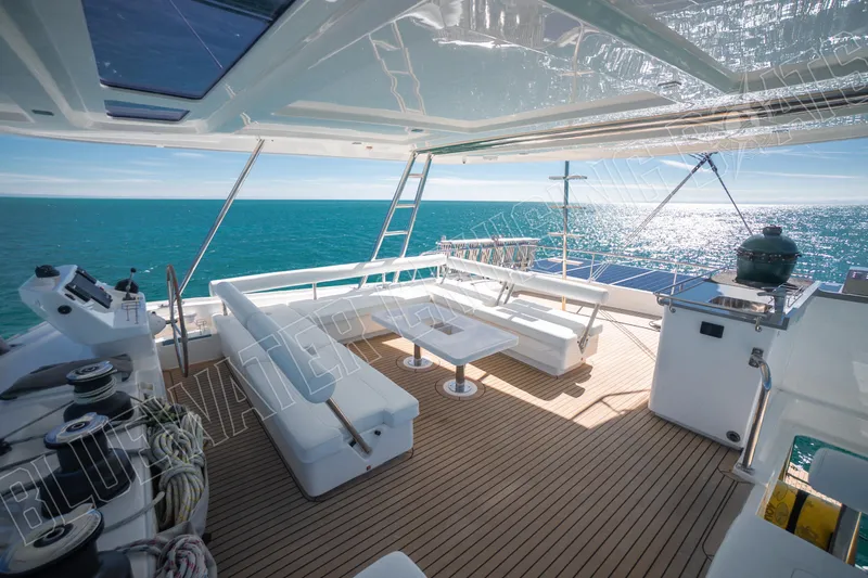 Sea Dog Yacht Photos Pics Luxurious Leopard 58 yacht deck with ocean view, featuring modern seating and navigation equipment.