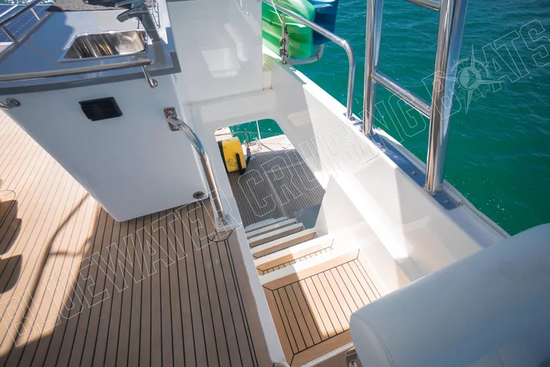Sea Dog Yacht Photos Pics Staircase on Leopard 58 yacht, 2020 model, leading to water with teak flooring.