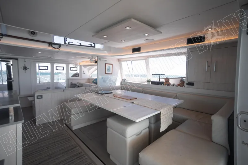 Sea Dog Yacht Photos Pics Luxurious interior of 2020 Leopard 58 yacht with modern dining area and ample seating.