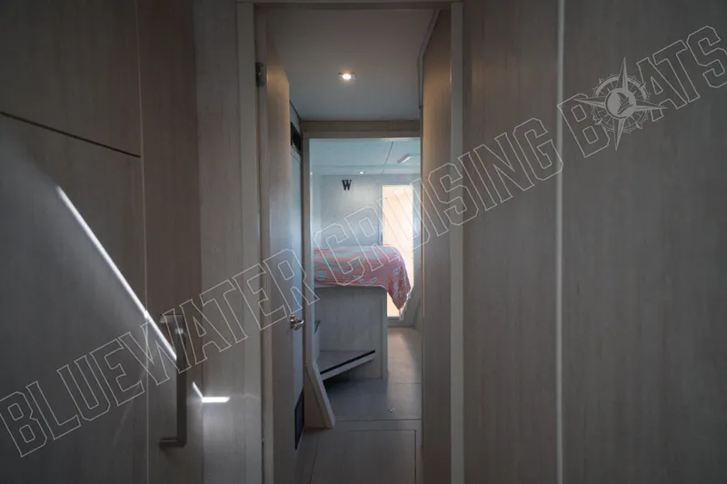 Sea Dog Yacht Photos Pics Hallway view inside a 2020 Leopard 58 yacht, leading to a cozy bedroom.