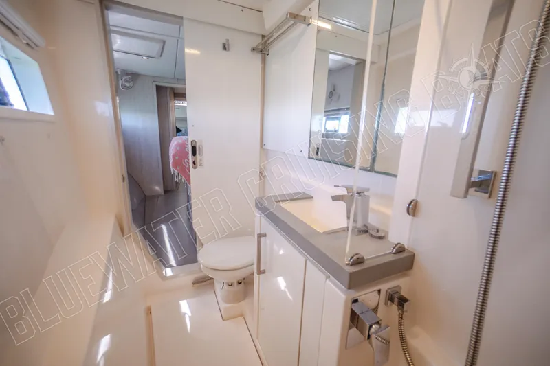 Sea Dog Yacht Photos Pics Modern bathroom interior on 2020 Leopard 58 yacht, featuring sleek fixtures and ample lighting.