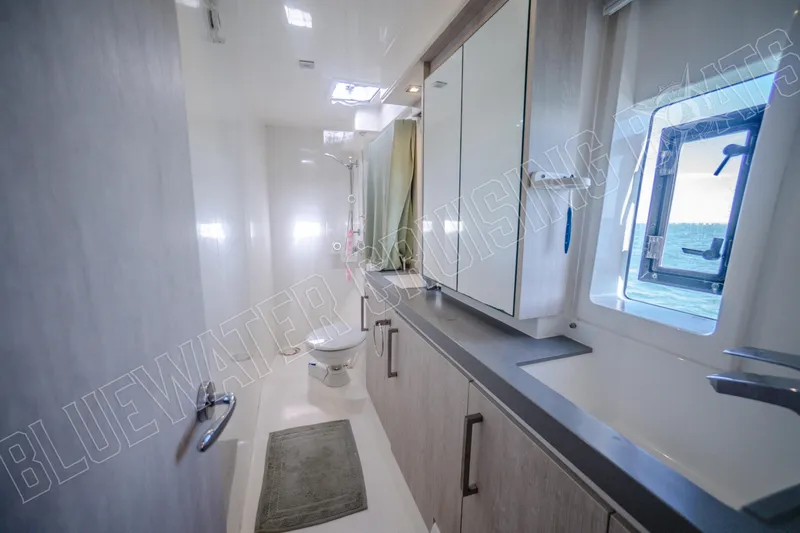 Sea Dog Yacht Photos Pics Modern bathroom interior on a 2020 Leopard 58 yacht, featuring sleek cabinetry and ocean view.
