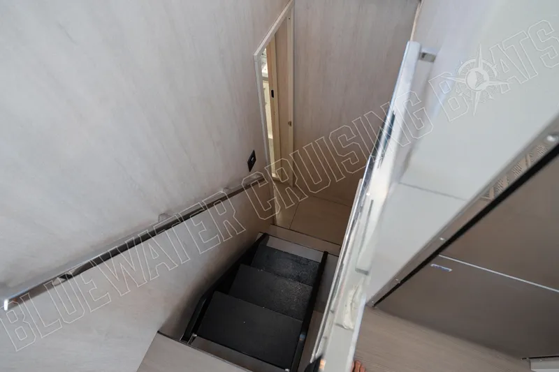 Sea Dog Yacht Photos Pics Staircase inside 2020 Leopard 58 yacht, featuring sleek modern design and handrail.
