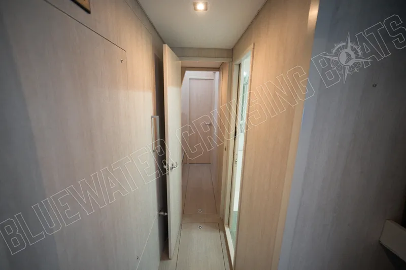 Sea Dog Yacht Photos Pics Narrow hallway inside 2020 Leopard 58 yacht, featuring light wood paneling and modern design.